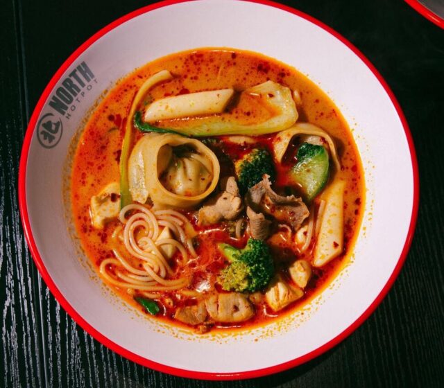 A North Hot Pot bowl of noodles, wontons, pork and greens in chilli broth
