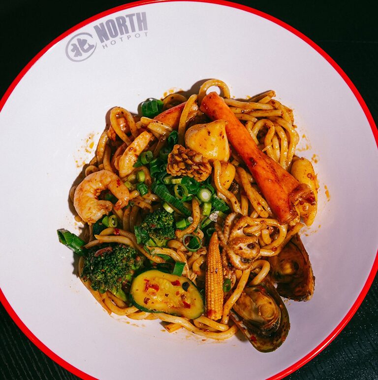A North Hot Pot bowl of seafood udon with prawns, squid, mussels, baby corn and greens