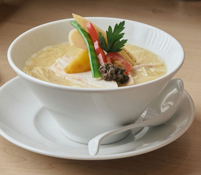 A bowl of Ginza Kagari Tori Paitan ramen with seasonal vegetables